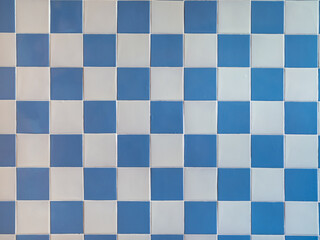 Real antique wall tiles background texture. White and blue checkered pattern.