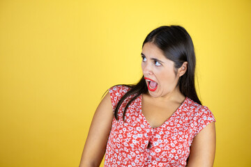 Young beautiful woman over isolated yellow background afraid and shocked with surprise expression, fear and excited face.