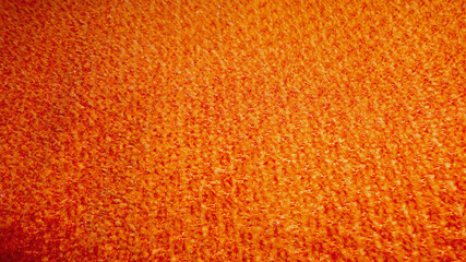 Fototapeta premium Orange fabric texture for background close up top view