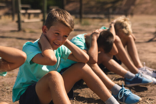 Group of boys performing sit ups at a bootcamp