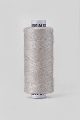 Thread Spool close up on a neutral background.