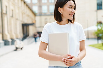 Optimistic young asian woman with laptop computer