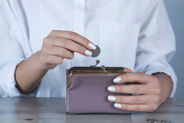 young woman hand holding coin with wallet.