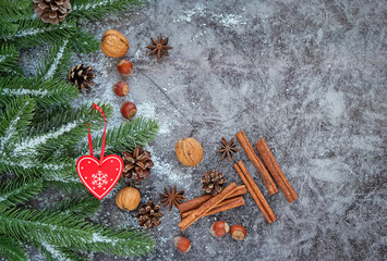 Christmas and New Year holiday background. winter season concept. Christmas decor, cinnamon, nuts and fir tree on wooden table.copy space