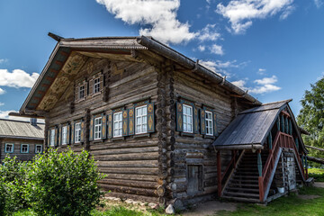 Wooden house on green grass with blue sky