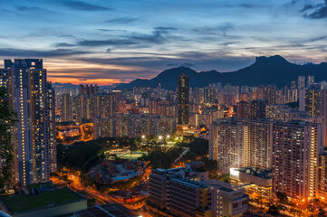 Panorama of Hong Kong city skyline and Lion Rock hill at dusk