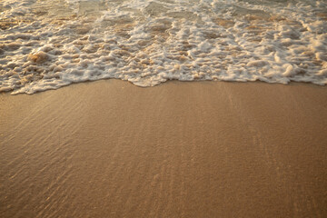 Scenic seascape. Milky foam waves at the beach. Sunset time. Waterscape for background. Selected soft art focus. Sunlight reflection on the water and sand. Balangan beach, Bali, Indonesia