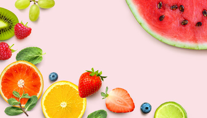 Healthy Fruit background. Colorful fresh fruits and berries on pink background.
