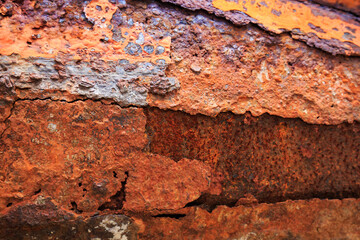 The iron is rusty, indented.