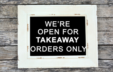 Fototapeta premium We're open for takeaway orders only text on chalkboard