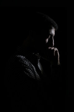 Thoughtful Man Against Black Background