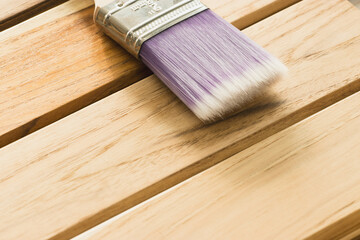 A carpenter paint brush used to improve and close the color of the wood to be beautiful.