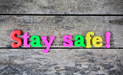 Fototapeta premium Stay safe words on a wooden table