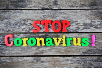 Stop coronavirus word written on wood block