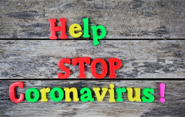 Help Stop Coronavirus words on a wooden table