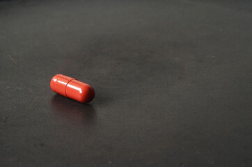 single pill open close up, red pill close up, active ingredient in medicine pill