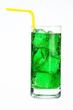 Vertical Isolated Shot Of A Glass Of Iced Carbonated Green Juice With A Straw