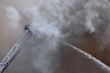 Firefighter Engulfed in Smoke on Ladder