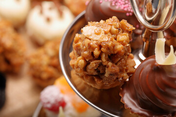 Caramel cupcake and catering sweets, closeup of various kinds of cakes on event or wedding reception.