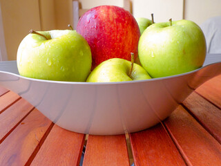 Delicious red and green apples on the table.