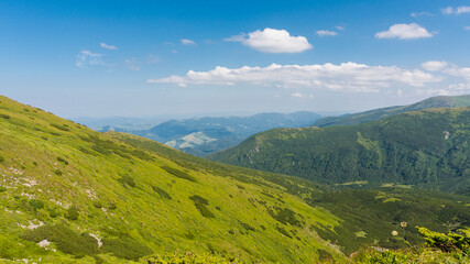 Fototapeta na wymiar Amazing mountain landscape with blue sky with white clouds, sunny summer day in Carpathians, Ukraine.