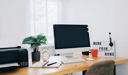 Modern office interior with electronic device, supplies and coffee cup on table