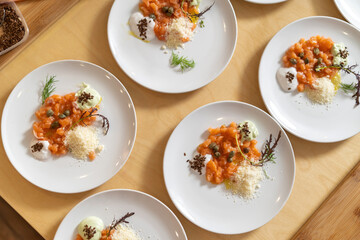 Smoked Salmon Topped with Capers, Cheese, Seeds and Sauce. Gourmet cuisine, luxury catering.