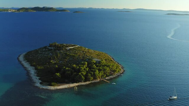 Aerial view of an islet with a  pine forest near Pakostane, Adriatic coast in Croatia