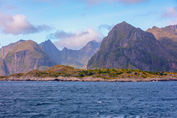 Open sea. View of the rocky seashore. Lighthouse on the shore. Beautiful nature of Northern Norway. Lofoten islands