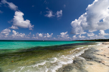 The ultramarine Caribbean sea with blue water and white clouds.