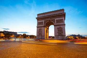 Fototapeta na wymiar The night view of triumphal arch and traffic in Paris, France.