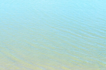 Top view of beautiful and peaceful sea water in light blue and turquoise tone with ripple for background and natural water surface concept