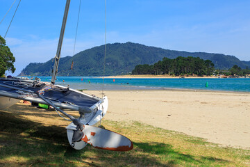 Beach at Taurua, a sunny holiday town on the Coromandel Peninsula, New Zealand. Across the harbor...