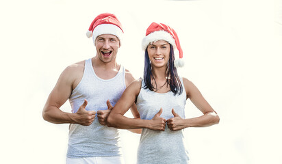 Obraz premium Couple in love in red santa hats. Couple in love. Christmas time. Celebration. White background.