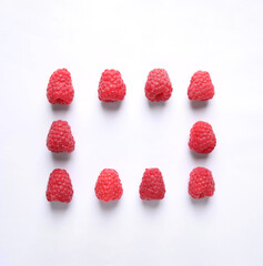 Frame of delicious ripe raspberries on white background, top view. Space for text