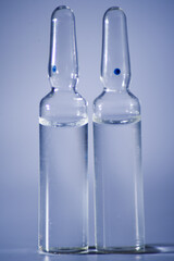 medical ampoules with liquid on a grey background close-up