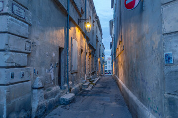 The ancient roman street and architecture in Arles, Provence, at sunset.