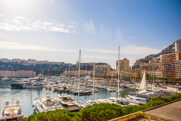 Naklejka premium The coastal view of the port and boats in Monaco, on a sunny day.