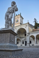 central plaza in Udine, Italy, at sunset with the Statue of Caco