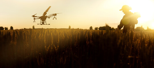Farmer controls drone sprayer with a digital tablet