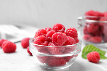 Delicious fresh ripe raspberries on light grey table