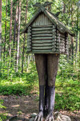 carved wood figure hut chicken legs