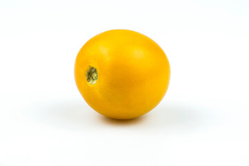 Yellow tomato close up isolated on white background.