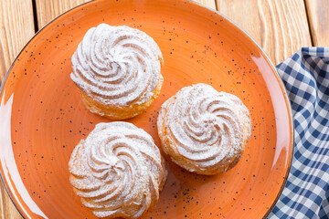 Small french cookies profitroles with sugar powder