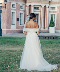 young slender bride in a long white elegant wedding dress. honeymoon ceremony