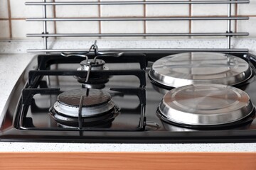 Clean surface of electric and gas hob, selective focus. Domestic kitchen. Kitchen stove top view....