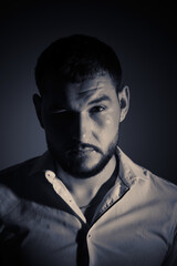 portrait of young guy with white shirt and beard