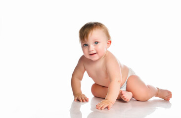 Portrait of a smiling little baby boy with blue eyes on a white background.