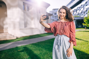 Cute college student making selfie