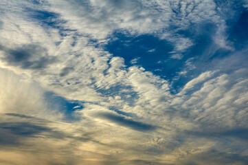 Sky with porous clouds at sunset. Nature background.